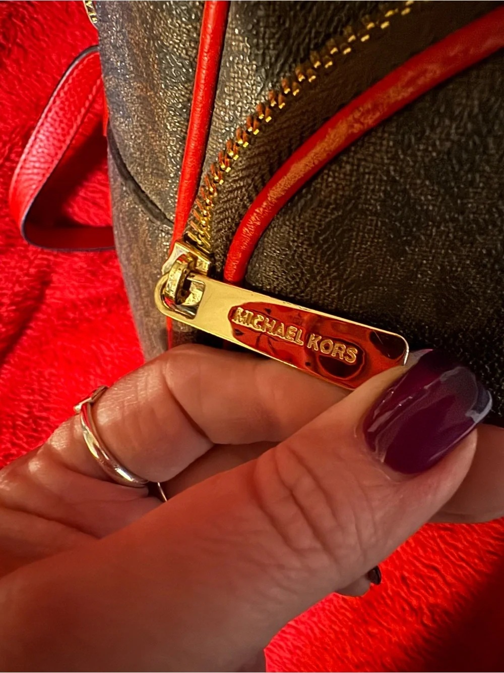 Michael Kors Brown Monogram Backpack with Red Trim and Gold Logo